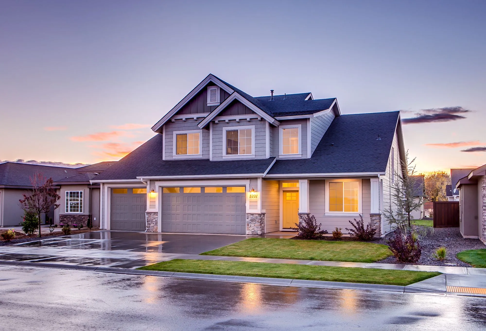 A family house lit from inside at dusk