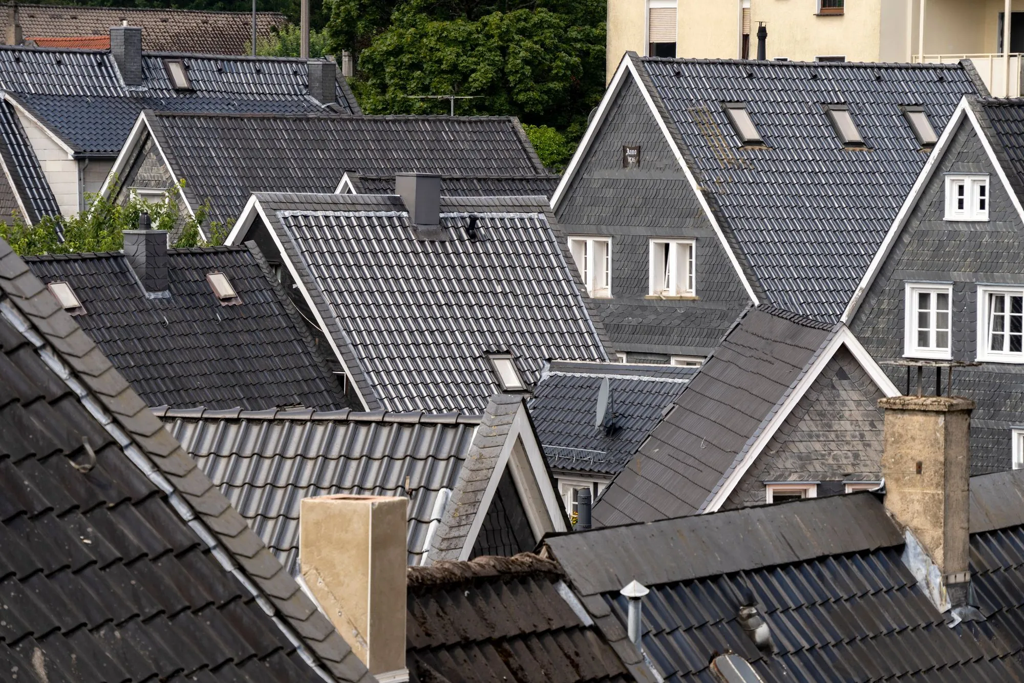 Pitched rooftops and dormers across a residential street